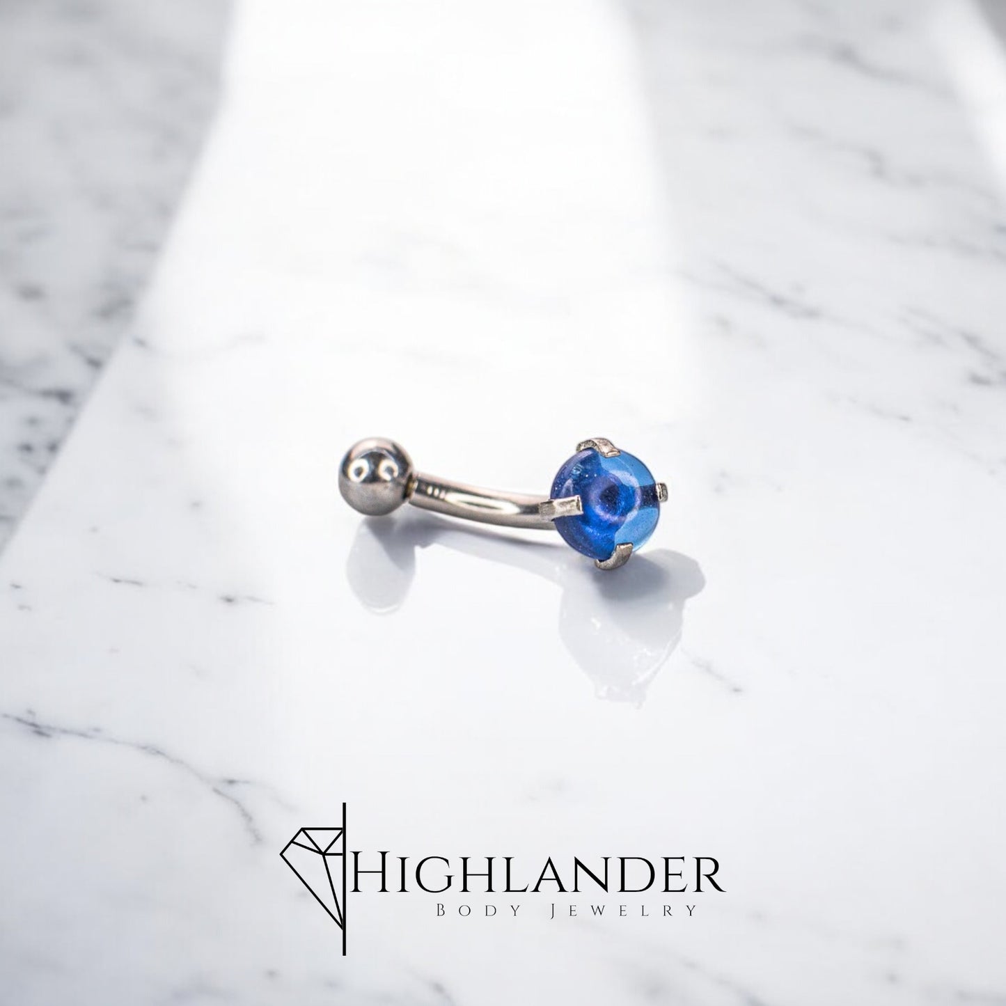 Blue CZ Cabochon Eyebrow Curved Barbell